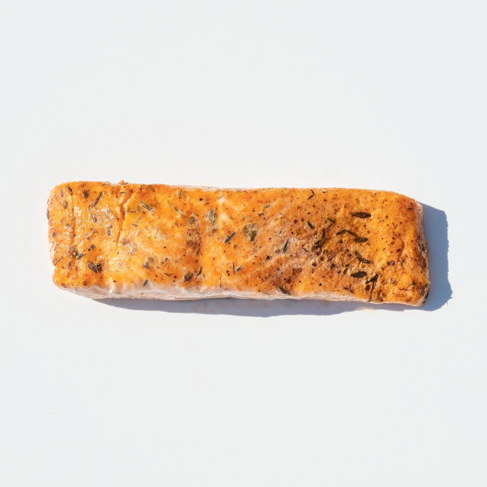 Frozen Skinless Lightly Blackened Atlantic Salmon Portions 10 Pound Each - 1 Per Case.
